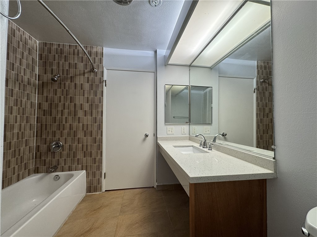 222 South Central Avenue, Unit 214 Los Angeles, CA 90012 - Photo 13 of 21 a bathroom with a sink mirror toilet and bathtub