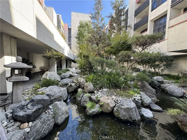 a view of a street with flower plants