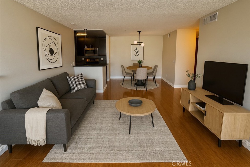 222 South Central Avenue, Unit 214 Los Angeles, CA 90012 - Photo 2 of 21 a living room with furniture and a flat screen tv