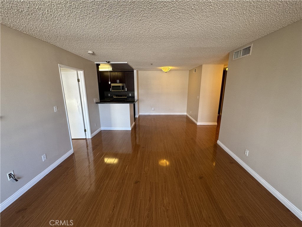 222 South Central Avenue, Unit 214 Los Angeles, CA 90012 - Photo 7 of 21 wooden floor in an empty room with a window
