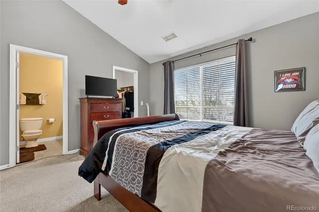 a bedroom with a large bed and a tv