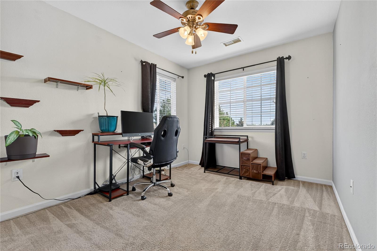 12799 Ivanhoe Street Thornton, CO 80602 - Photo 21 of 30 a workspace with chandelier fan and a window