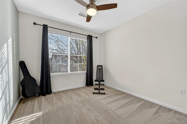 a view of a workspace with furniture and a window