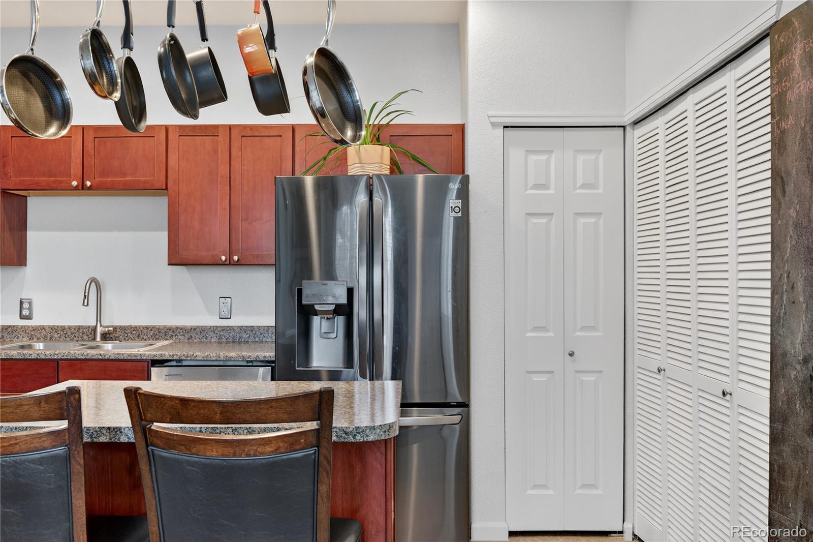 12799 Ivanhoe Street Thornton, CO 80602 - Photo 4 of 30 a kitchen with stainless steel appliances granite countertop a refrigerator and a sink