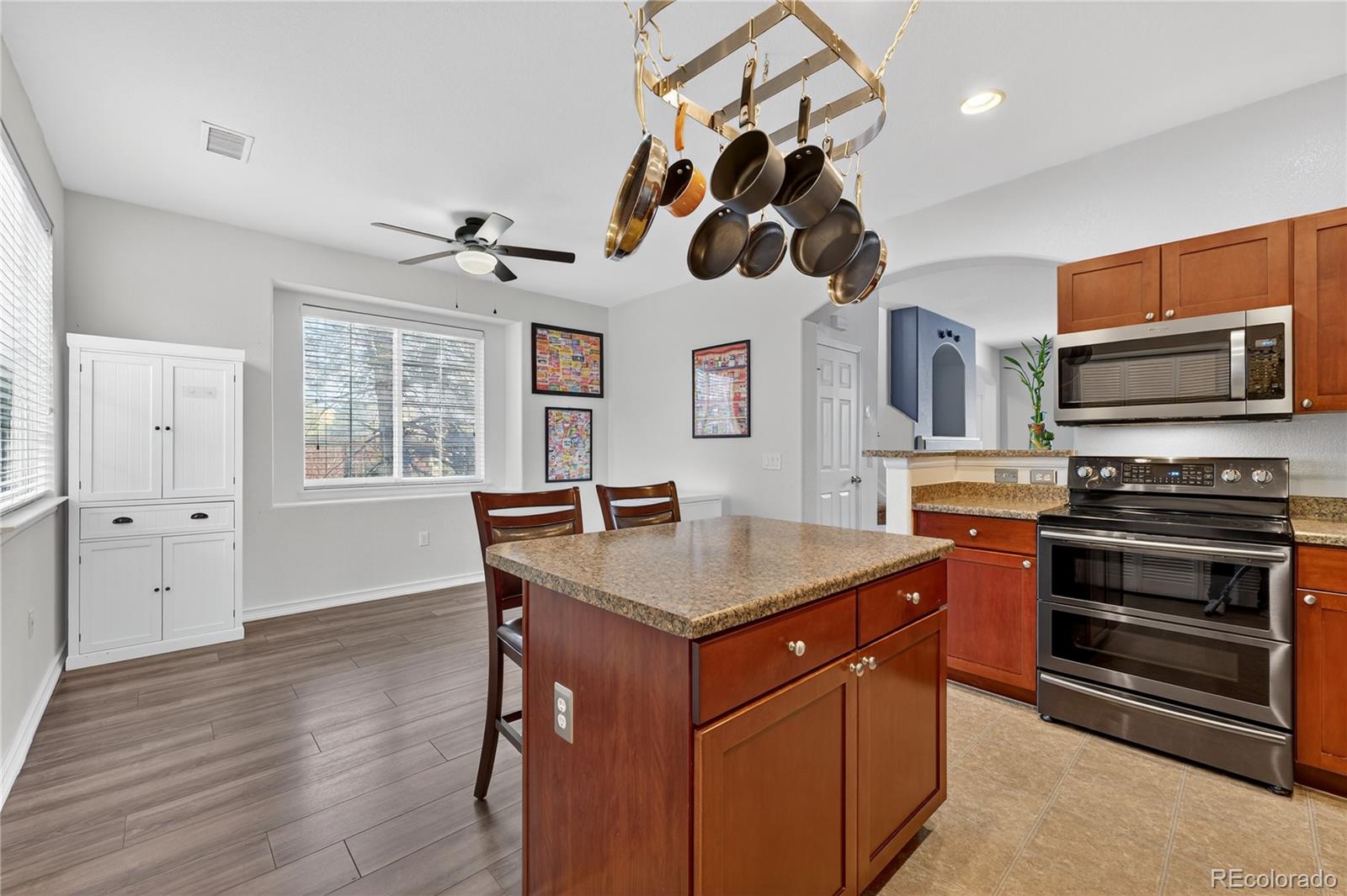 12799 Ivanhoe Street Thornton, CO 80602 - Photo 5 of 30 a kitchen with a stove a sink and a refrigerator