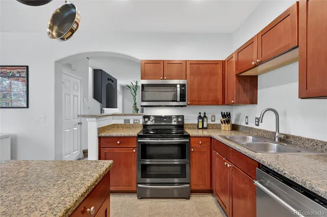 a kitchen with stainless steel appliances granite countertop a stove and a sink