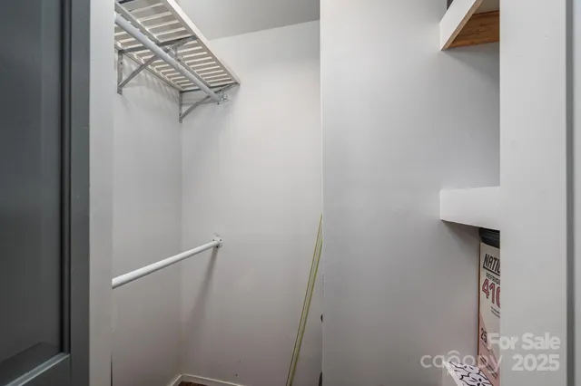 a view of staircase with wooden floor and white walls