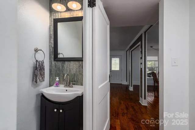 a bathroom with a sink a toilet and mirror