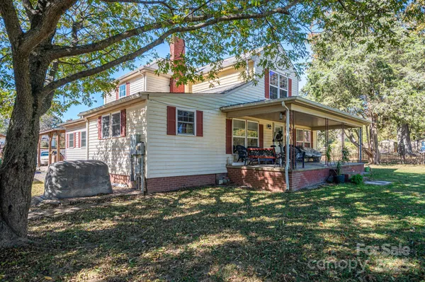 a view of a house with a yard porch and sitting area