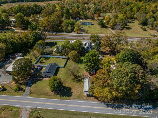 an aerial view of house with a yard