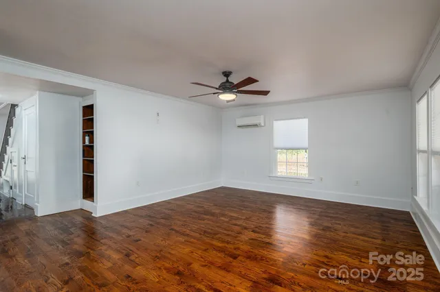 a view of a livingroom with a ceiling fan and window