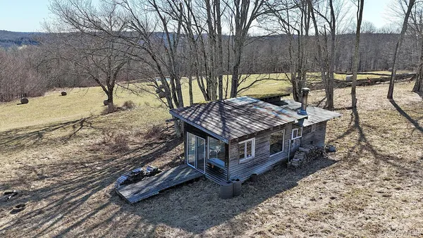 a view of a backyard with a small deck and a wooden floor