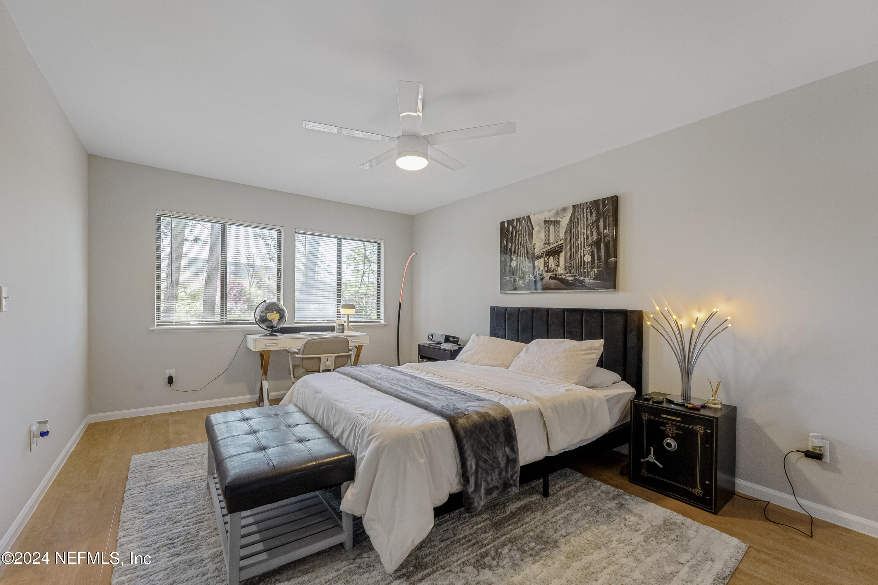 8118 Baymeadows Circle East, Unit 5 Jacksonville, FL 32256 - Photo 15 of 23 a bedroom with a bed and wooden floor