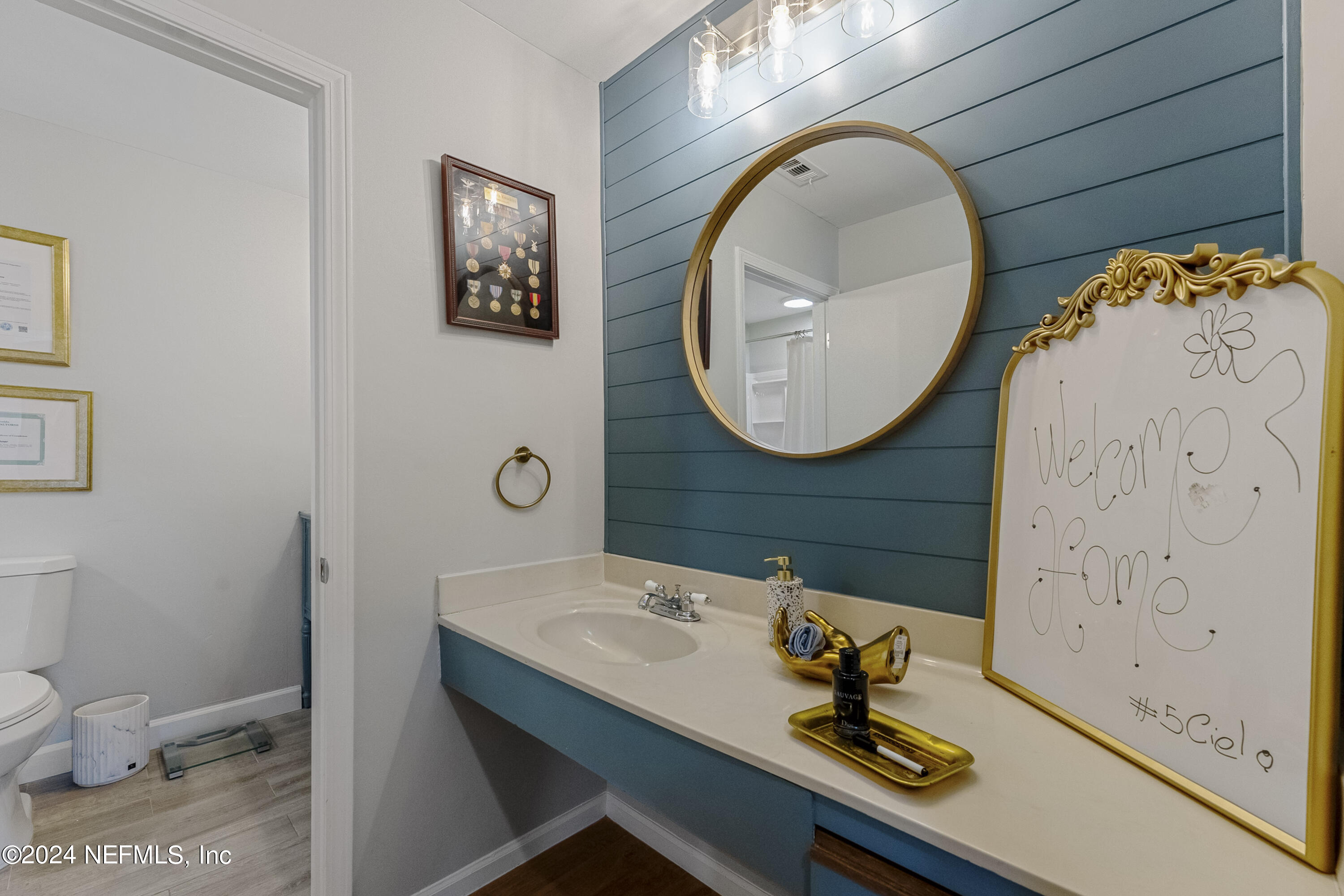 8118 Baymeadows Circle East, Unit 5 Jacksonville, FL 32256 - Photo 16 of 23 a bathroom with a sink mirror and toilet