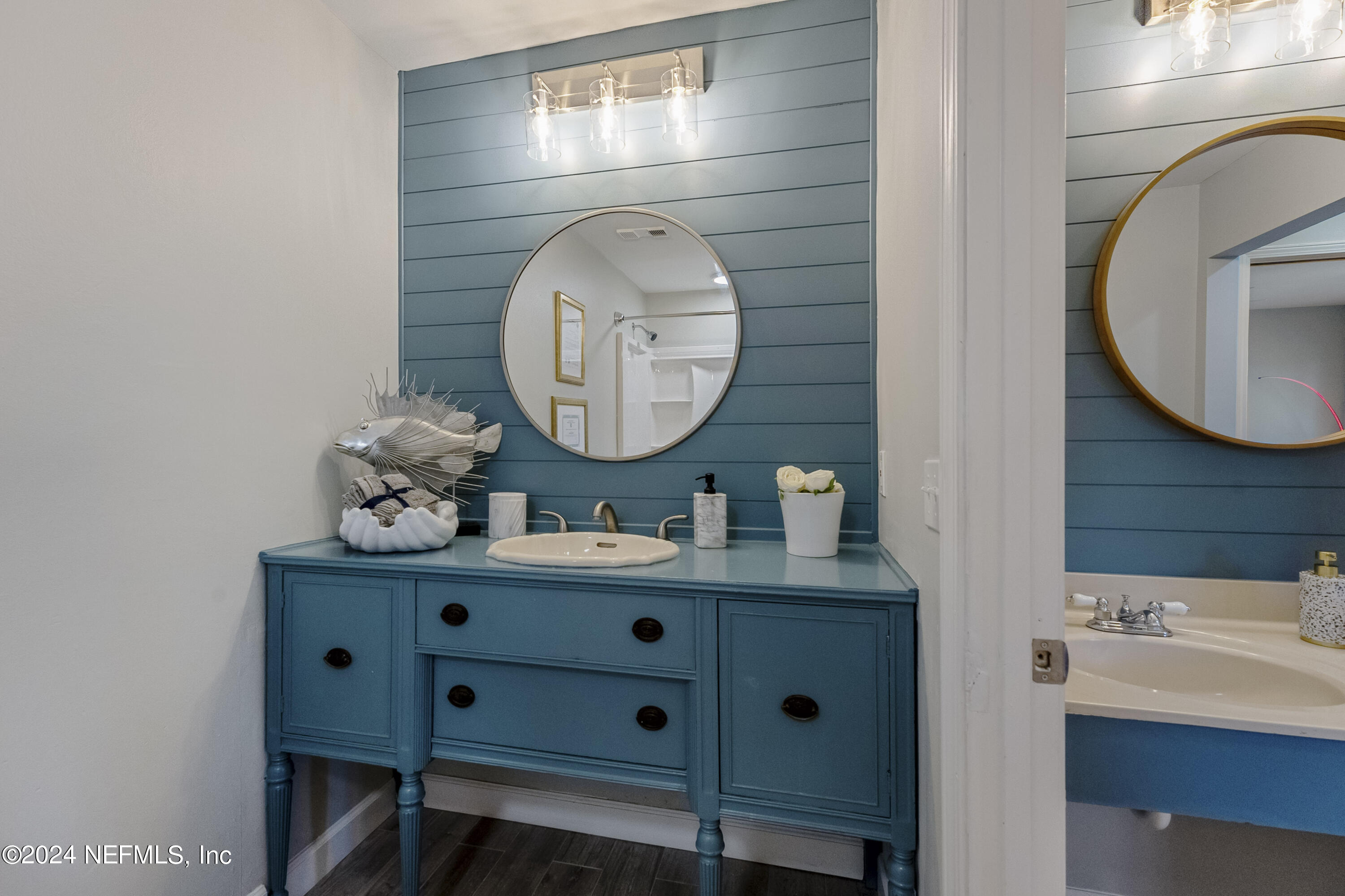 8118 Baymeadows Circle East, Unit 5 Jacksonville, FL 32256 - Photo 17 of 23 a bathroom with a sink mirror and vanity