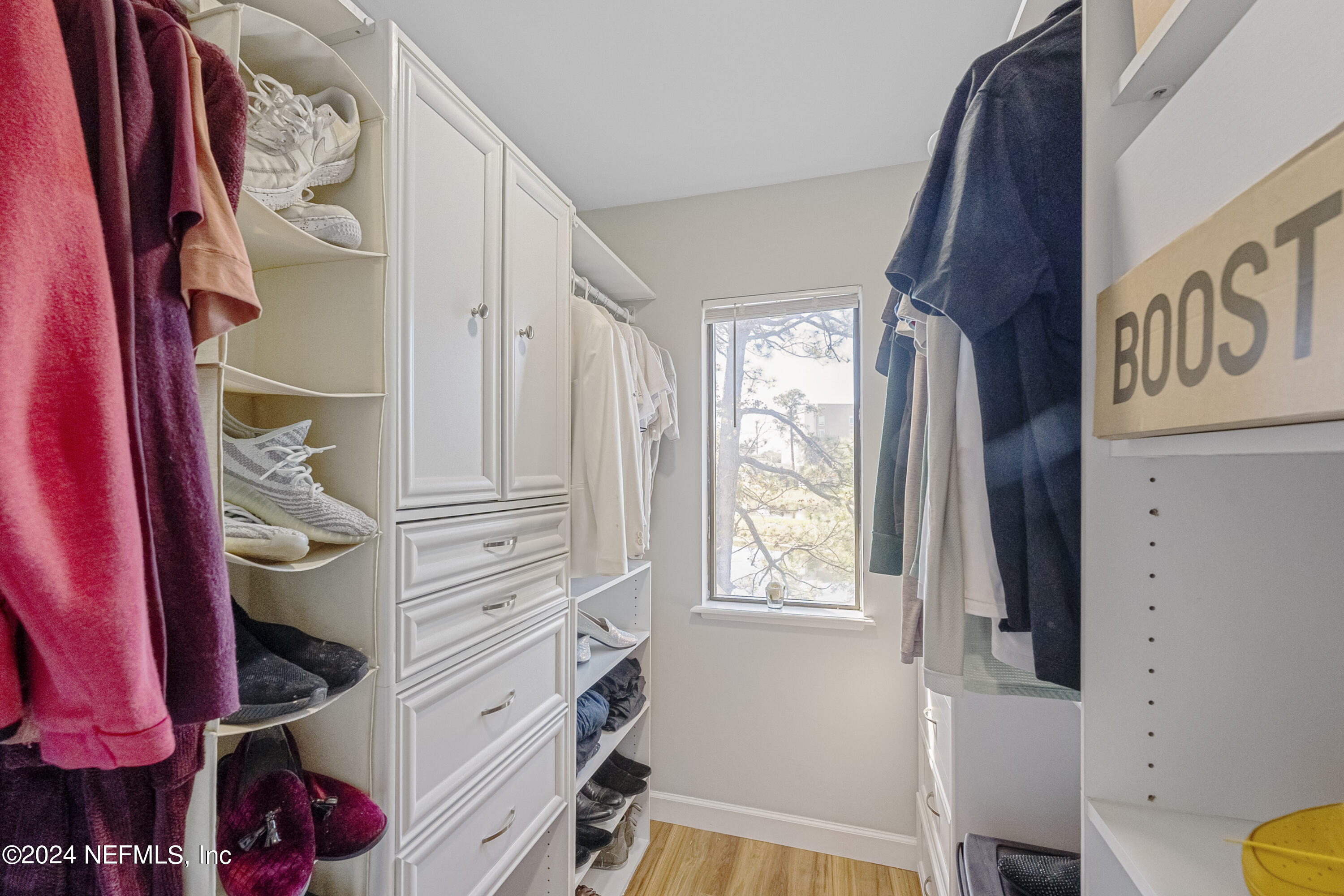 8118 Baymeadows Circle East, Unit 5 Jacksonville, FL 32256 - Photo 19 of 23 a view of walk in closet with clothes and shoes