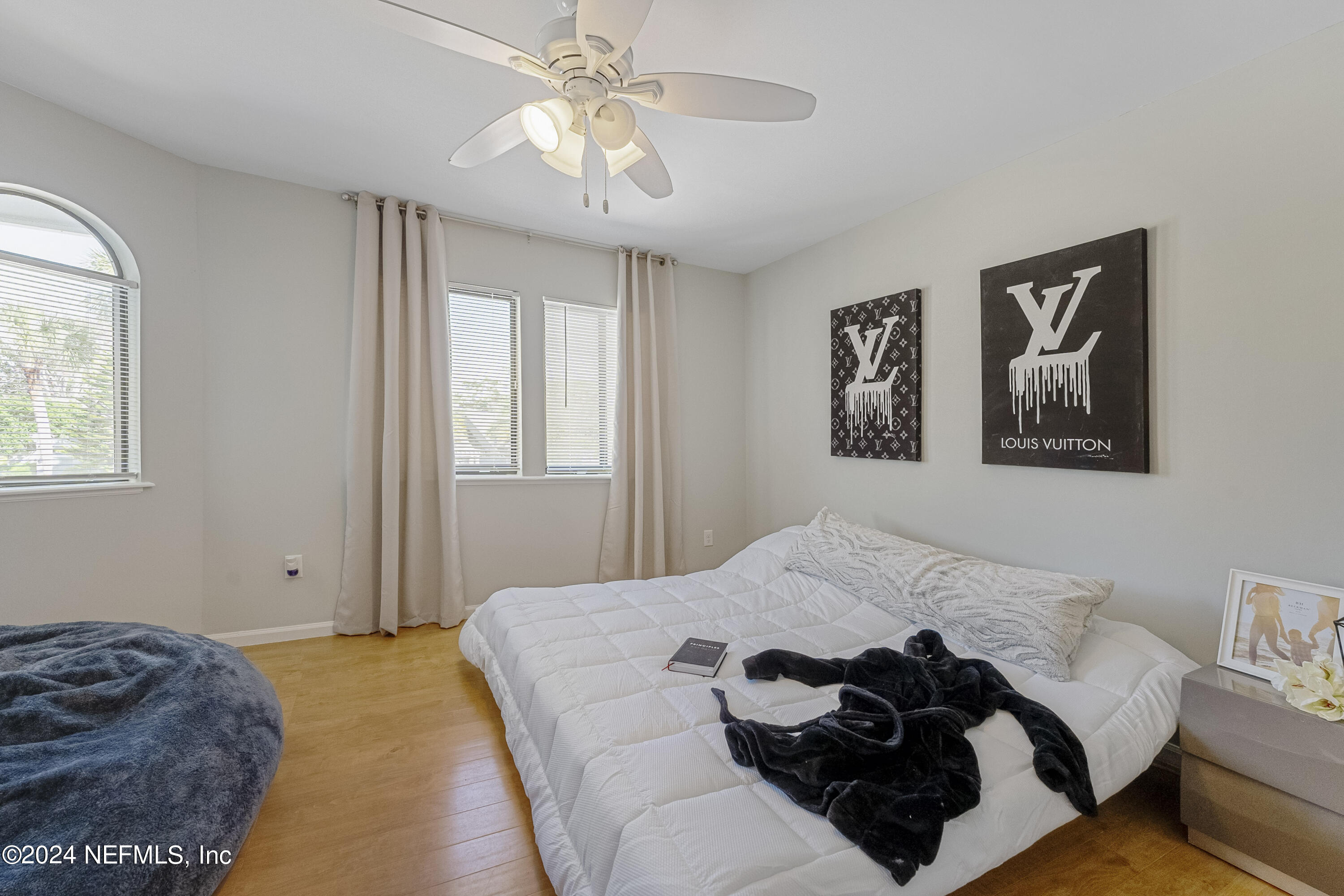 8118 Baymeadows Circle East, Unit 5 Jacksonville, FL 32256 - Photo 20 of 23 a bedroom with a bed and wooden floor