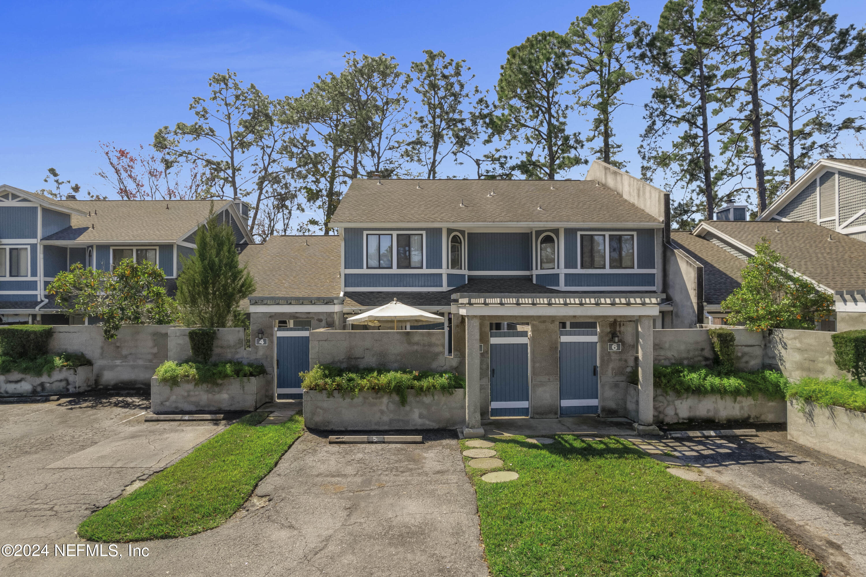8118 Baymeadows Circle East, Unit 5 Jacksonville, FL 32256 - Photo 3 of 23 a front view of a house with a garden and plants