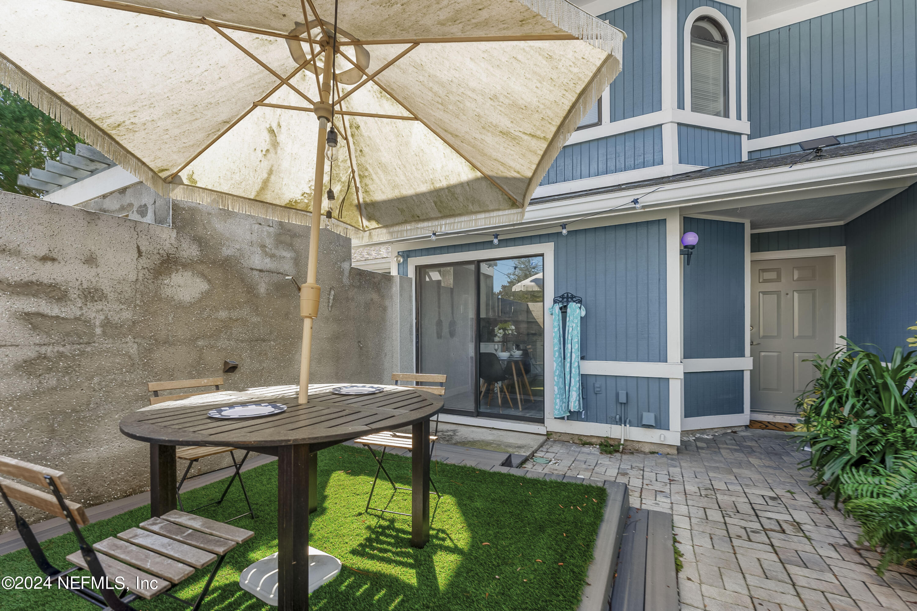 8118 Baymeadows Circle East, Unit 5 Jacksonville, FL 32256 - Photo 4 of 23 a view of a backyard with a table and chairs