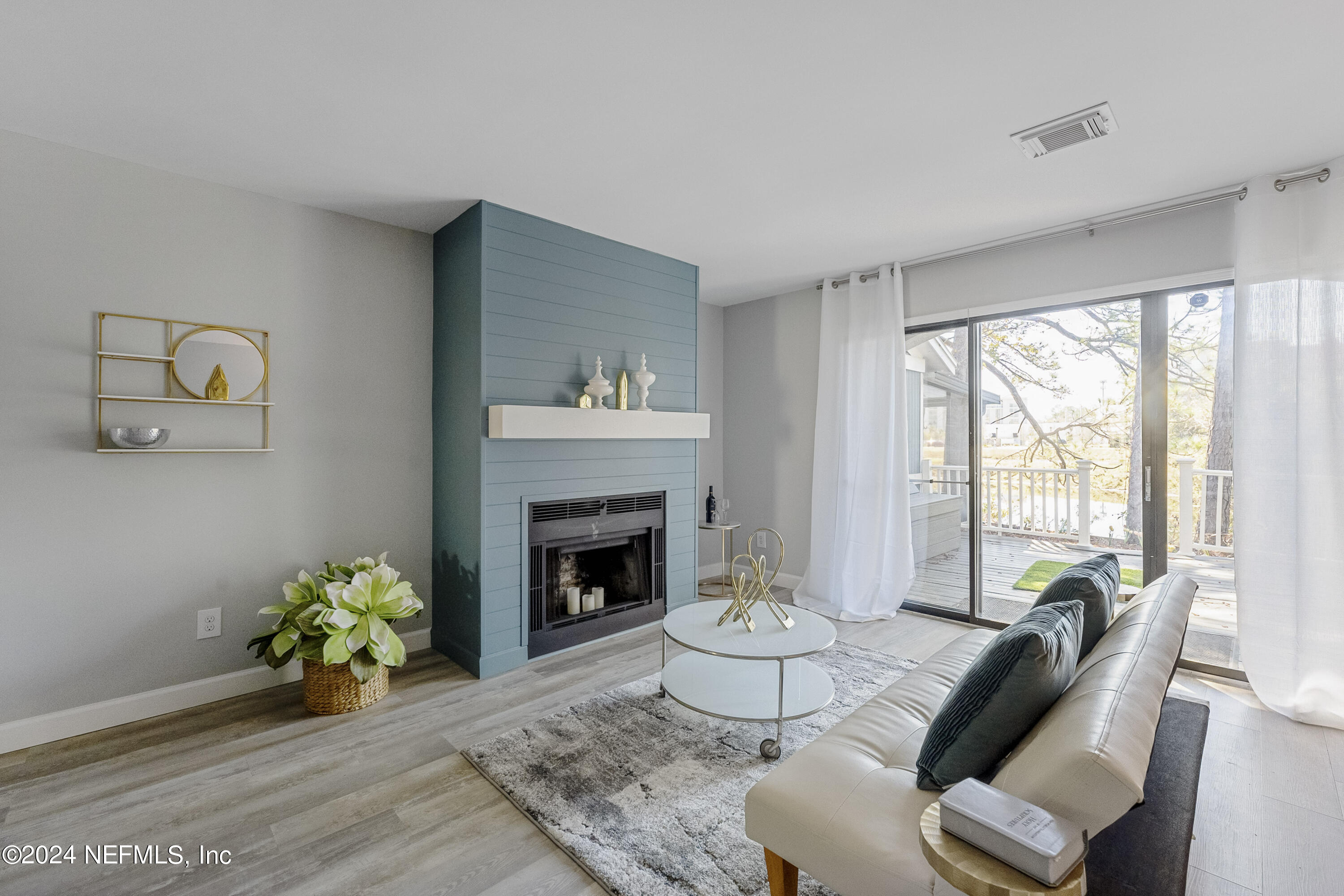 8118 Baymeadows Circle East, Unit 5 Jacksonville, FL 32256 - Photo 5 of 23 a living room with furniture and a fireplace