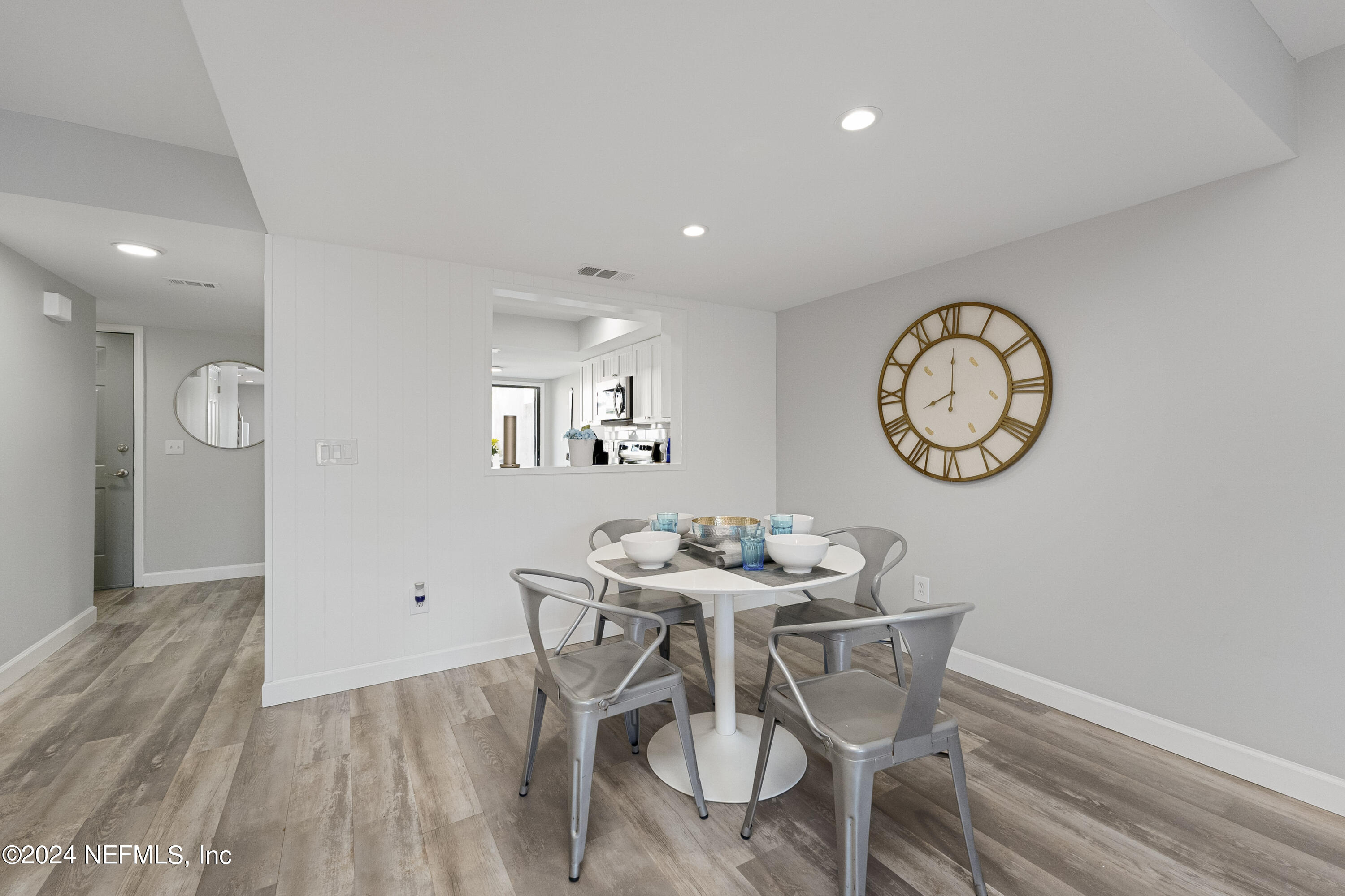 8118 Baymeadows Circle East, Unit 5 Jacksonville, FL 32256 - Photo 7 of 23 a view of a dining room with furniture and a mirror
