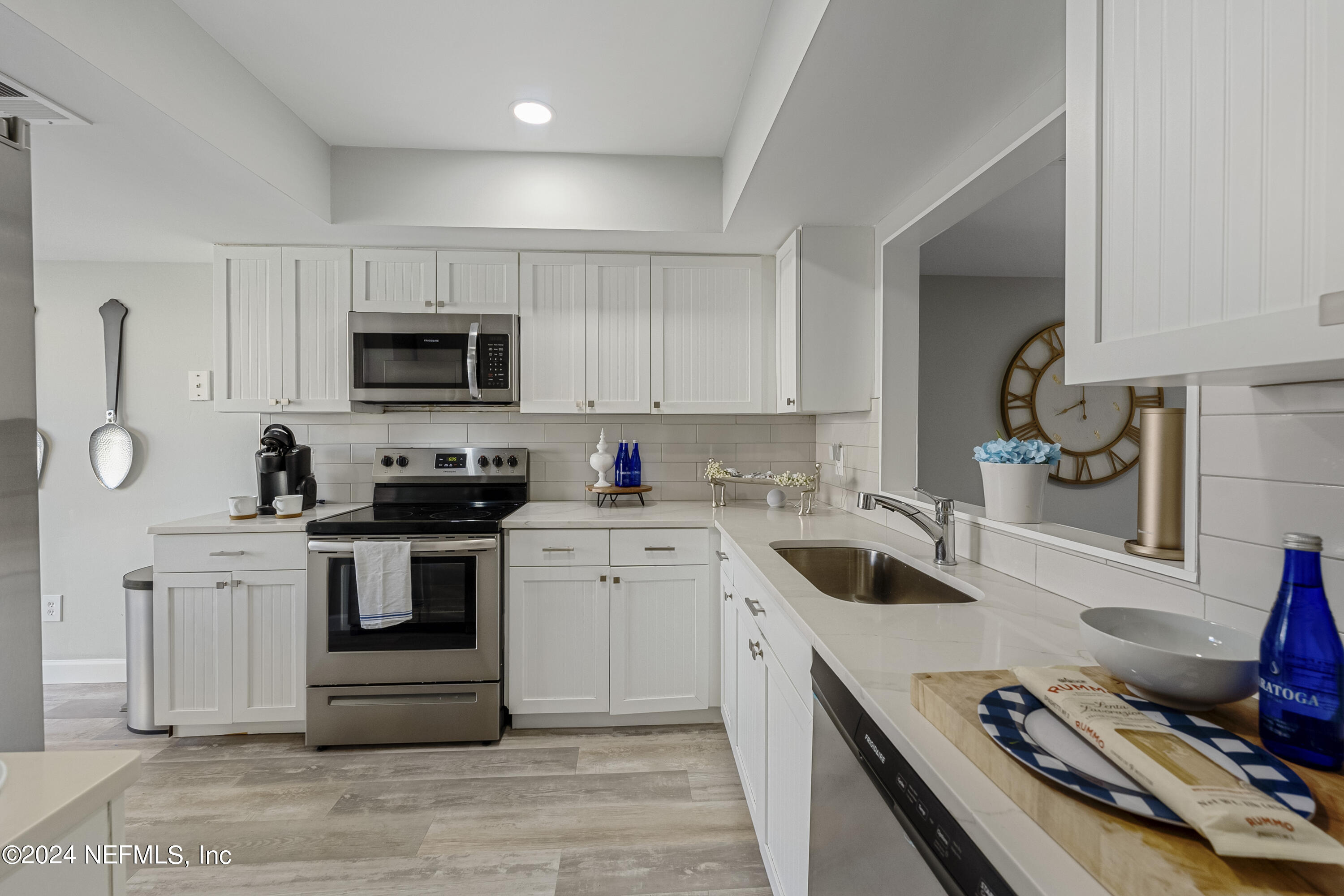 8118 Baymeadows Circle East, Unit 5 Jacksonville, FL 32256 - Photo 8 of 23 a kitchen with white cabinets and appliances