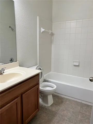a bathroom with a sink a toilet and a bathtub