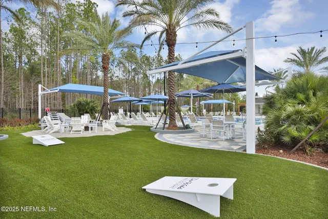 a view of a house with backyard outdoor seating area and furniture