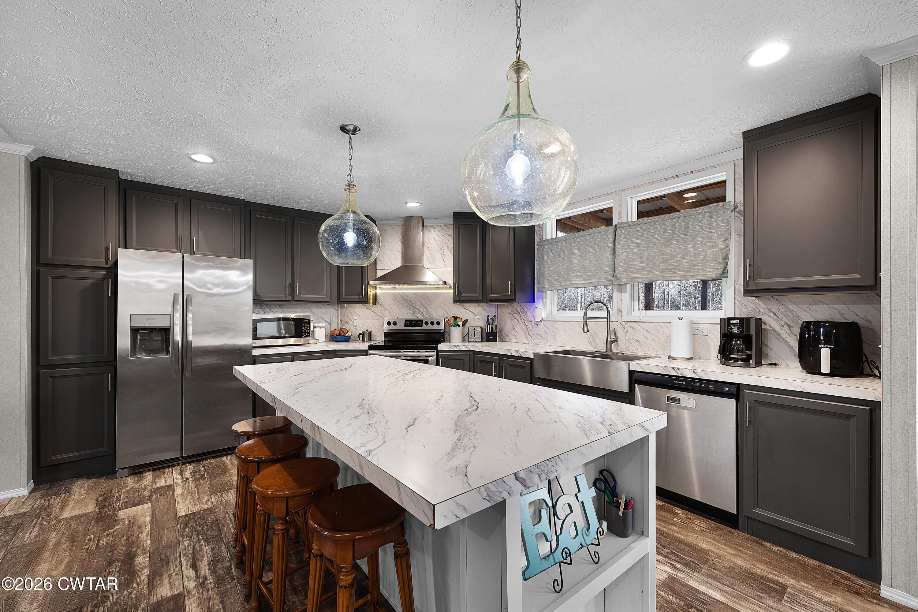 77 Vernon White Road Bradford, TN 38316 - Photo 5 of 24 a kitchen with stainless steel appliances granite countertop a sink a stove and a refrigerator