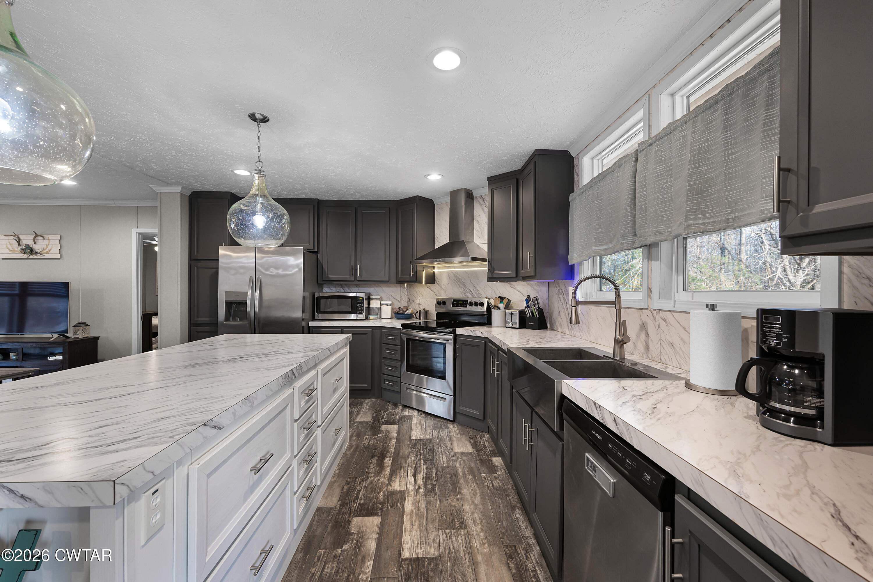77 Vernon White Road Bradford, TN 38316 - Photo 6 of 24 a kitchen with stainless steel appliances kitchen island granite countertop a sink stove cabinets and wooden floor