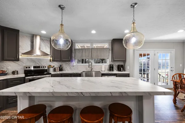 a large kitchen with a table and chairs