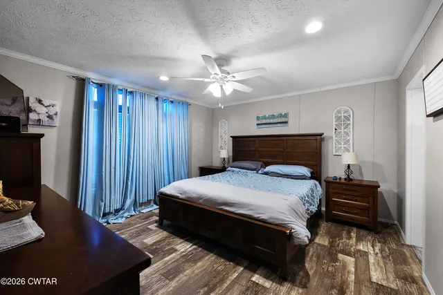 a bedroom with bed and wooden floor