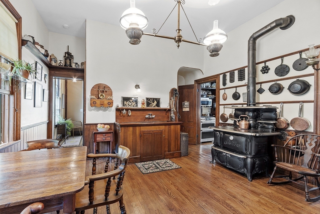 2 West Main Street Brookfield, MA 01506 - Photo 24 of 42 a kitchen with stainless steel appliances granite countertop a stove top oven a sink a dining table and chairs with wooden floor