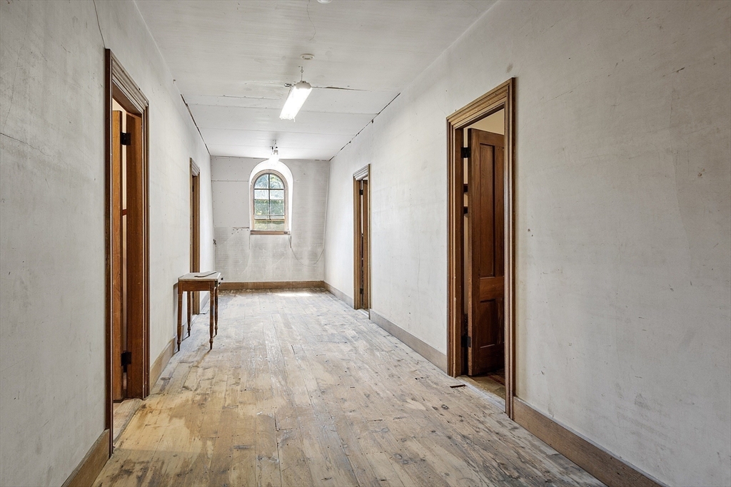 2 West Main Street Brookfield, MA 01506 - Photo 41 of 42 a view of a hallway with wooden floor and a living room
