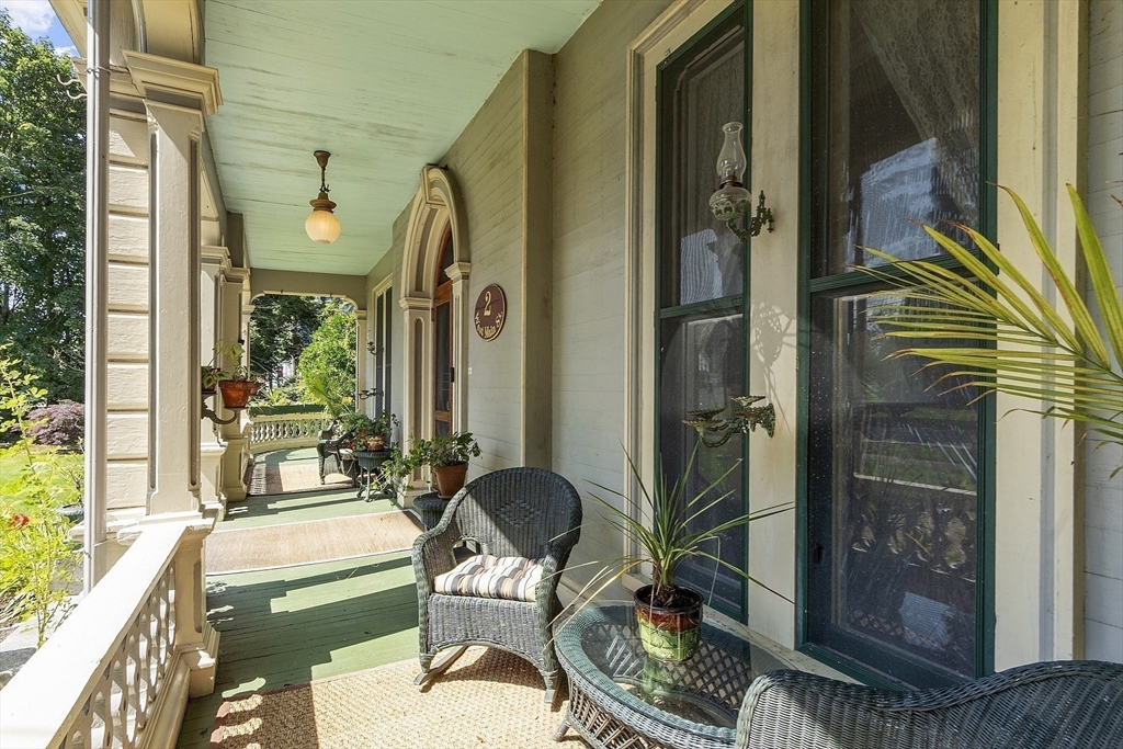2 West Main Street Brookfield, MA 01506 - Photo 5 of 42 a balcony with chairs and a table