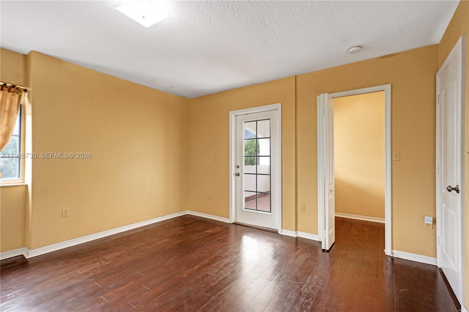 5502 Southwest 162nd Place Miami, FL 33185 - Photo 49 of 72 a view of an empty room with wooden floor and a window