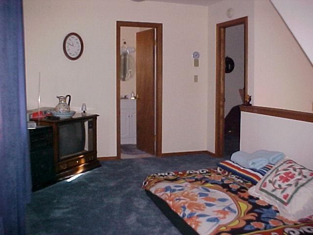 1138 Kilmer Road Tobyhanna, PA 18466 - Photo 13 of 15 a bedroom with a bed and a chandelier
