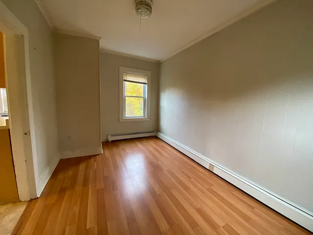 a view of an empty room and wooden floor