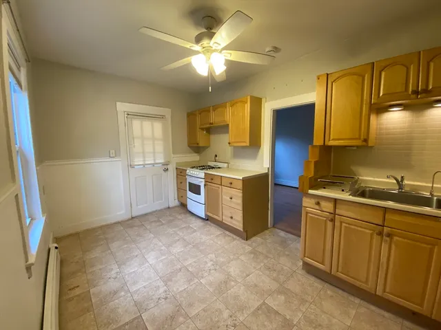 a kitchen with a stove a sink and a refrigerator
