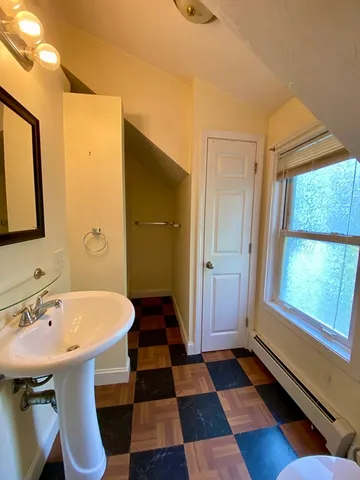 a bathroom with a sink a toilet a mirror and shower