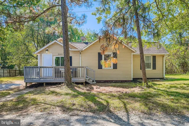 a view of a house with a yard and wooden fence