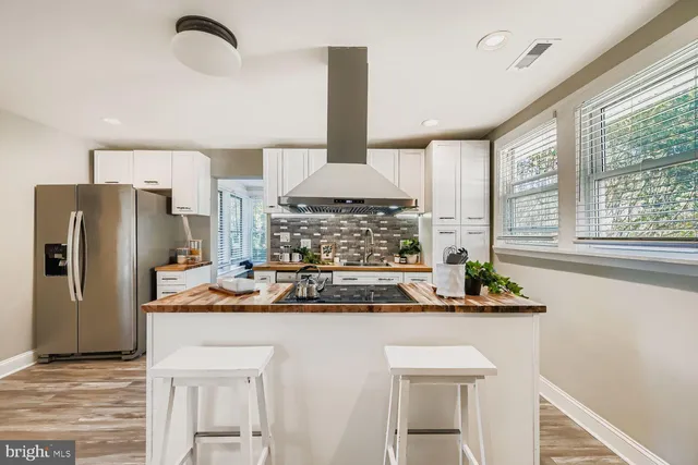 a kitchen with a sink a refrigerator and a stove