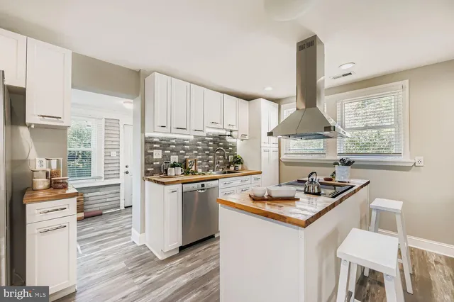 a kitchen with granite countertop a sink appliances a counter space and cabinets