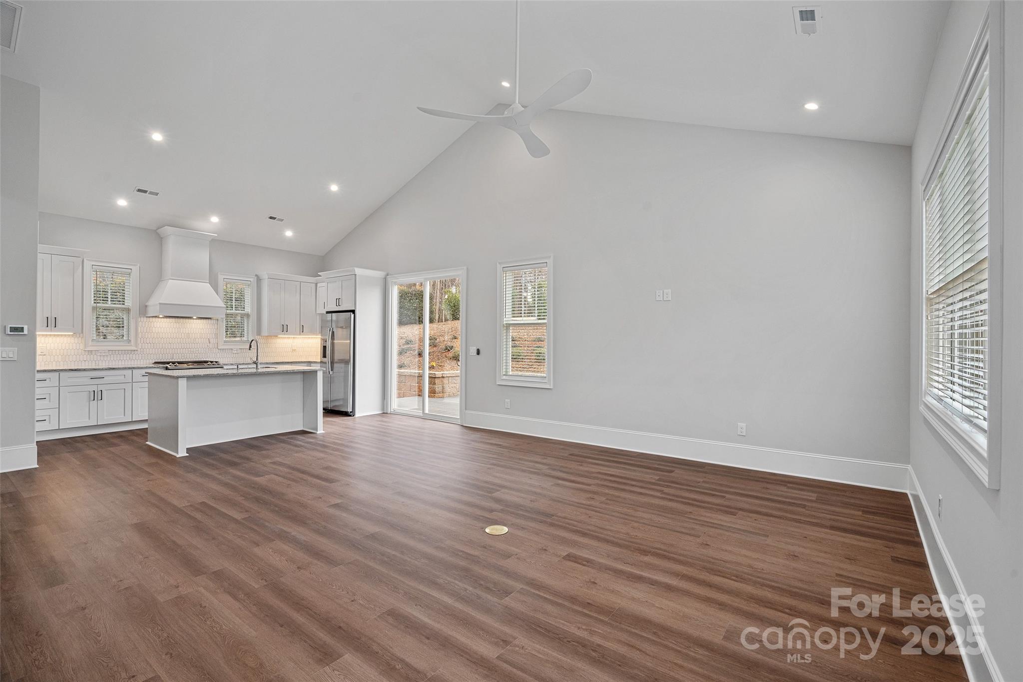 805 Naples Drive Davidson, NC 28036 - Photo 4 of 16 a view of kitchen with wooden floor and windows