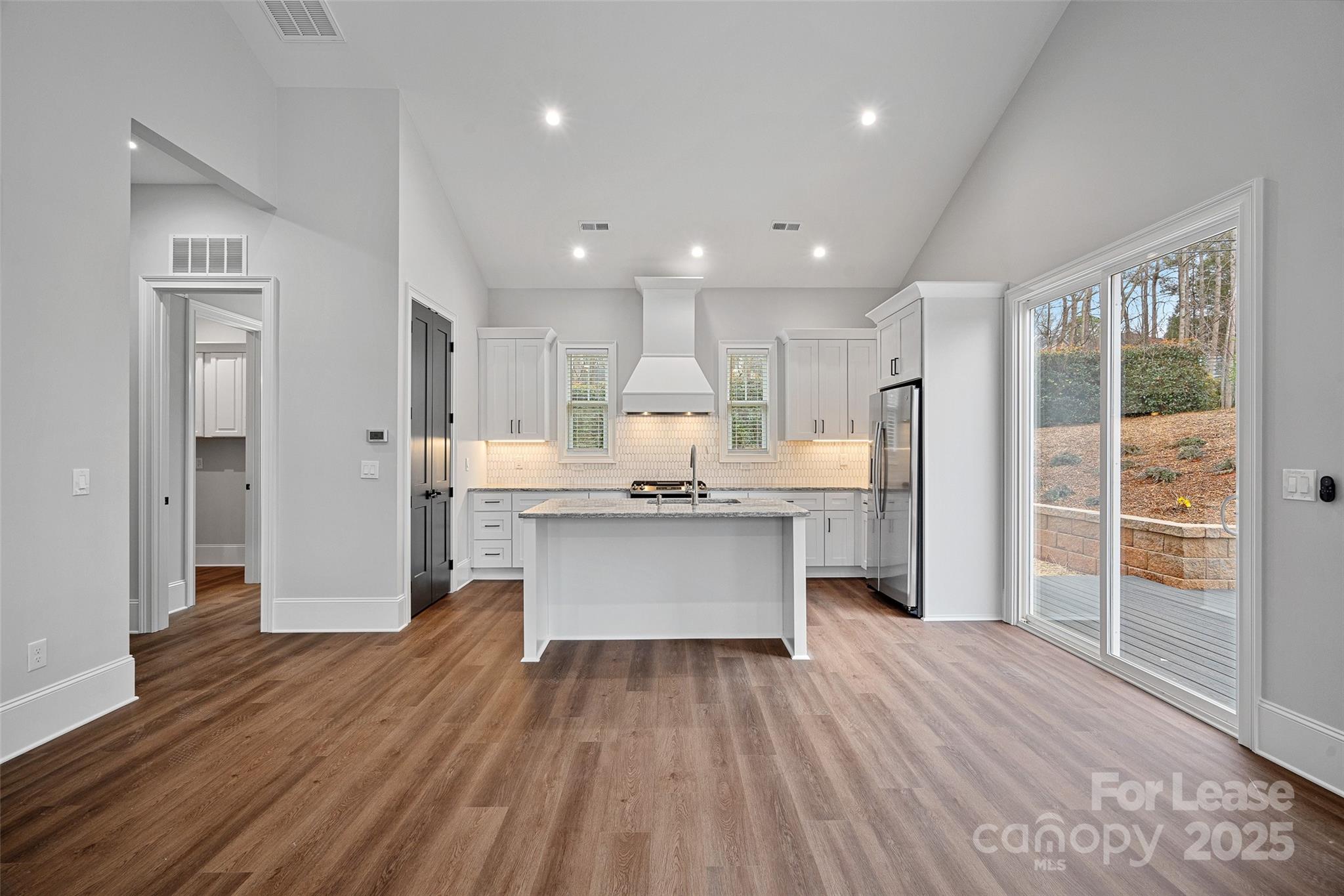 805 Naples Drive Davidson, NC 28036 - Photo 5 of 16 a large kitchen with a large window and stainless steel appliances