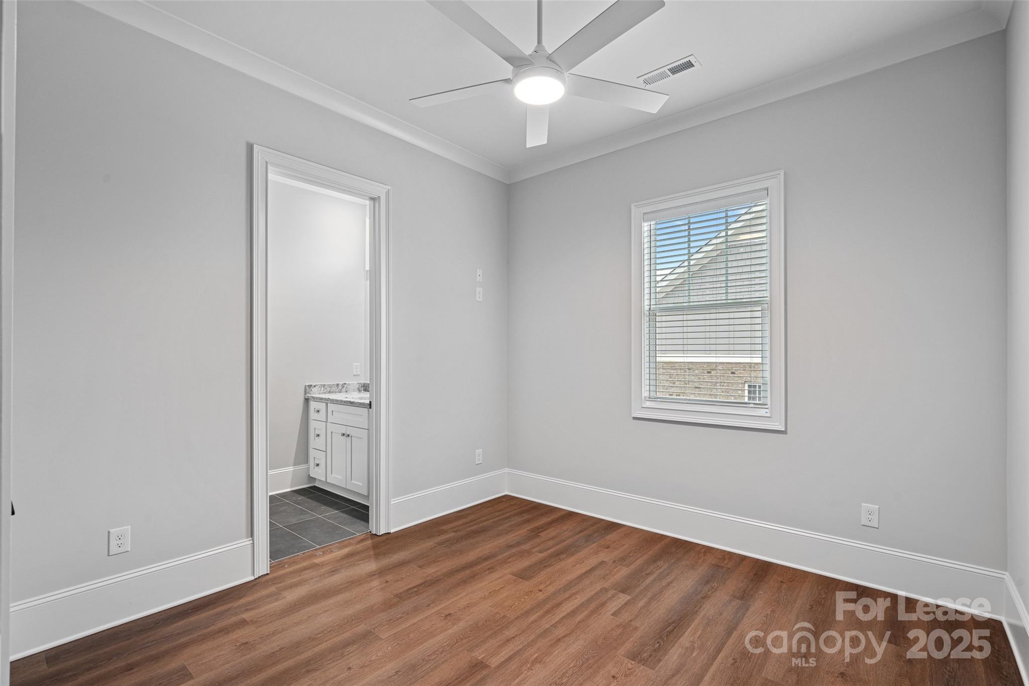 805 Naples Drive Davidson, NC 28036 - Photo 8 of 16 an empty room with wooden floor closet and windows