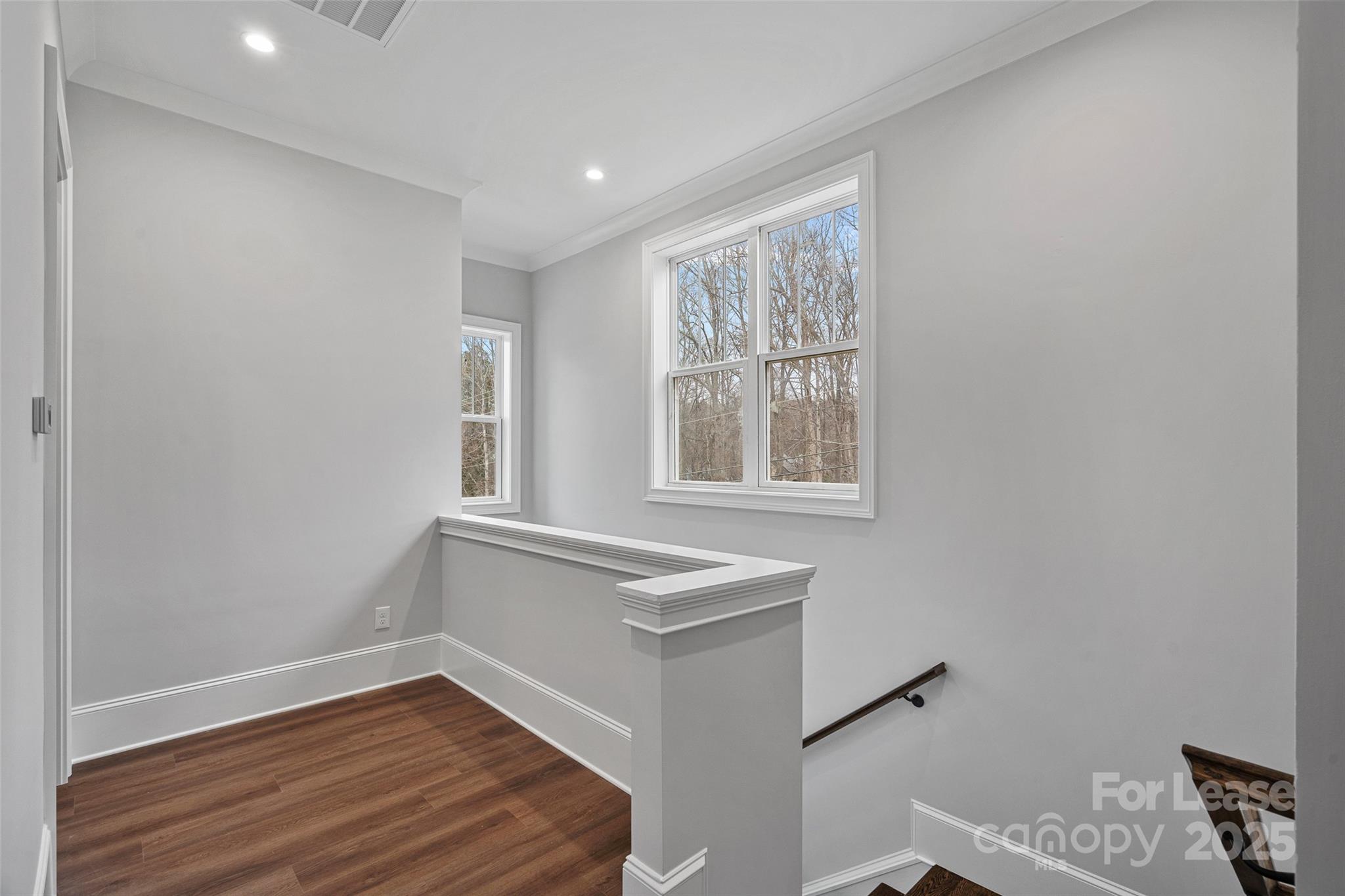805 Naples Drive Davidson, NC 28036 - Photo 9 of 16 a view of an empty room with wooden floor and a window