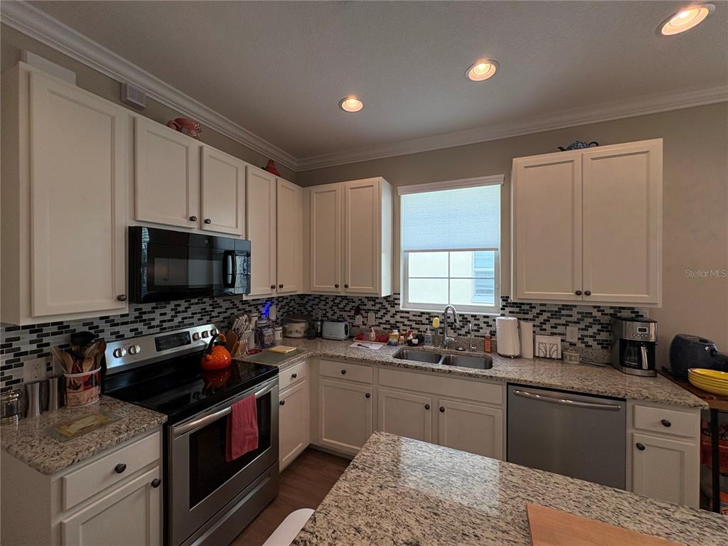 103 Cutlass Way Oldsmar, FL 34677 - Photo 13 of 20 a kitchen with a sink stove top oven and microwave