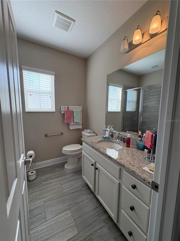 103 Cutlass Way Oldsmar, FL 34677 - Photo 20 of 20 a bathroom with a granite countertop sink mirror and toilet