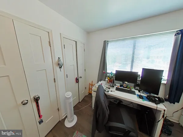 a view of a workspace with furniture and a gate